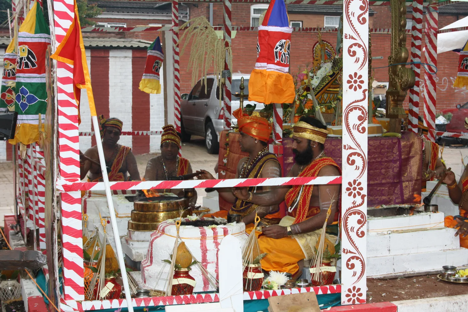 The ground outside dressed for the rites, vessels set out and the flags raised.