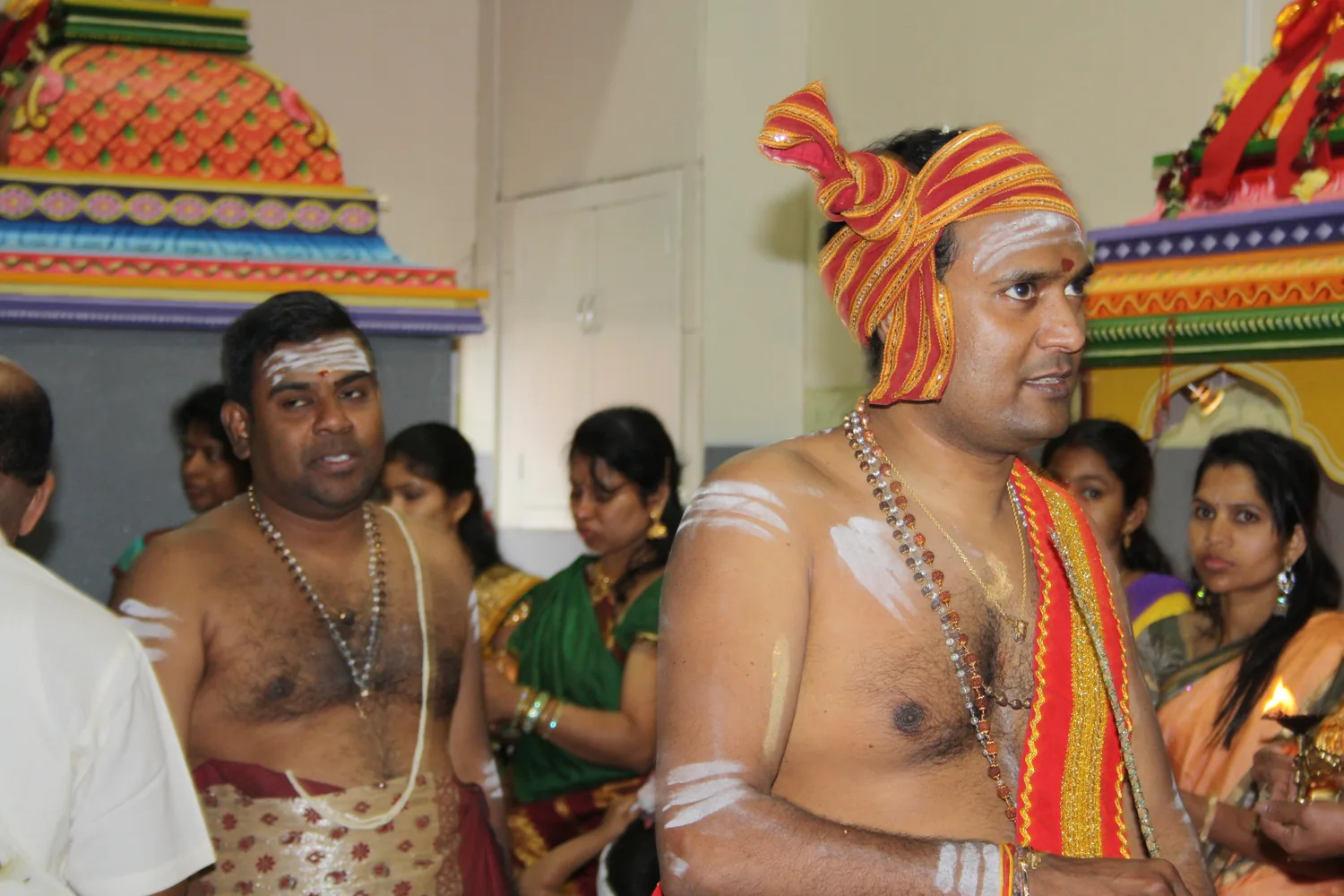 Priests in their turbans, the congregation behind.
