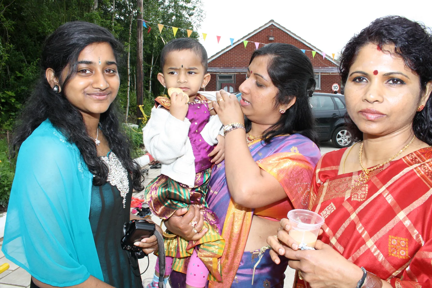 Outside during the day, families waiting.