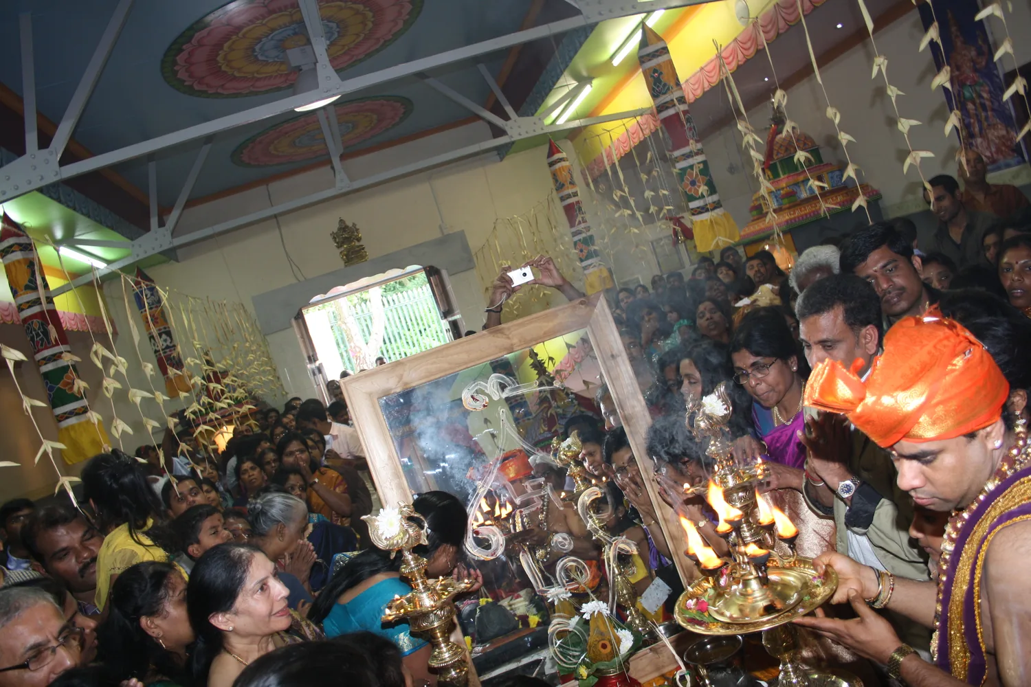 Aarti at the height of it — lamps and smoke over the crowd.