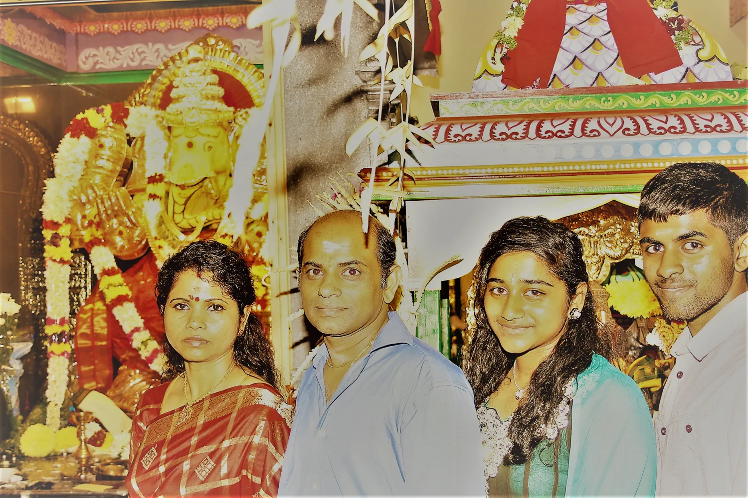 Four before the shrine, garlands still fresh.
