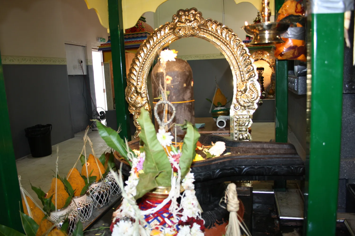 Mango leaves and vessels set at the shrine.